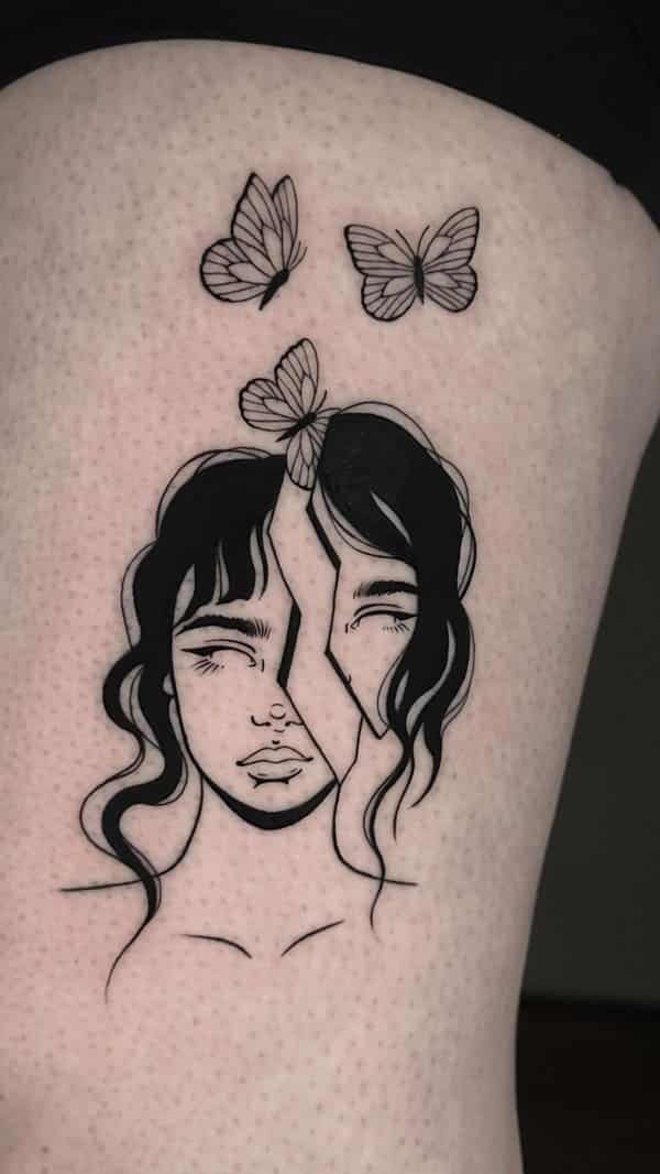 Blackwork tattoo of a girls face split in two pieces with three butterflies above it.