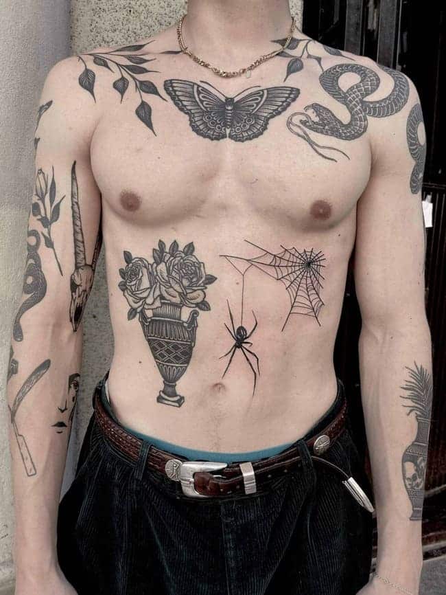 Blackwork tattoos of different animals on a males upper body.